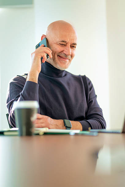 istock Senior businessman sitting at office desk and working 2217831134