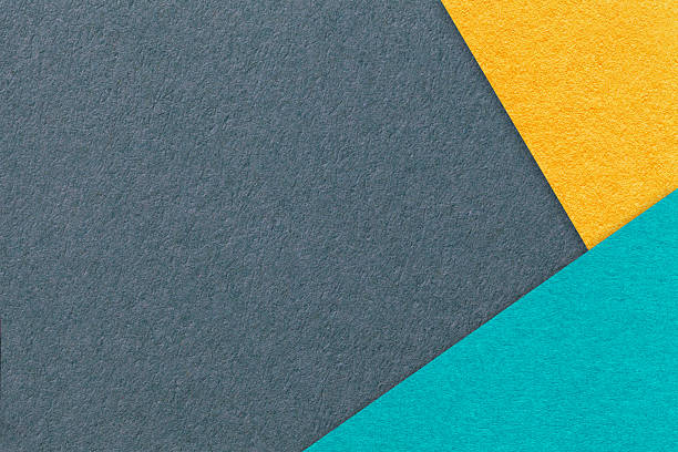 istock Abstract dark gray, yellow and turquoise paper background with copy space. Template for presentation and banner 2217833326