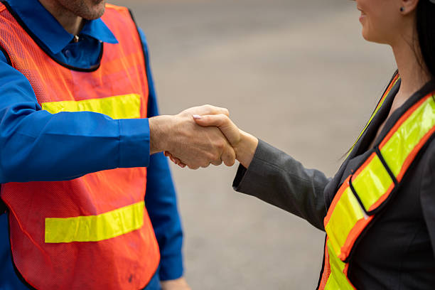 istock Caucasian man hand shake with woman engineer worker at container site 2217833513