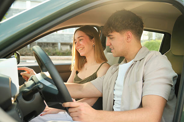 istock Young Couple Exploring Navigation System in Electric Car 2217835240