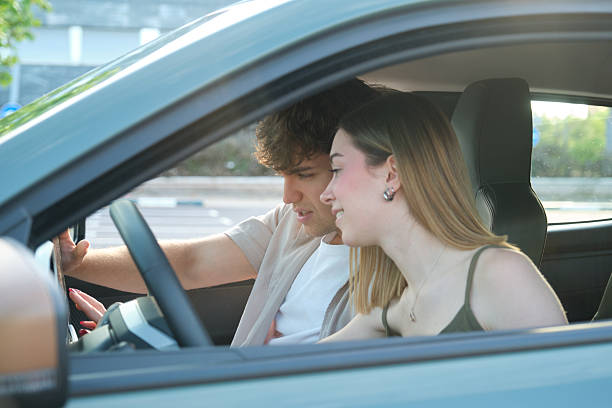 istock Young Couple Exploring Electric Car Features Together 2217835383