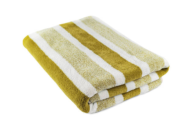 istock Carefully folded soft striped bath khaki towel isolated on white background 2217837062