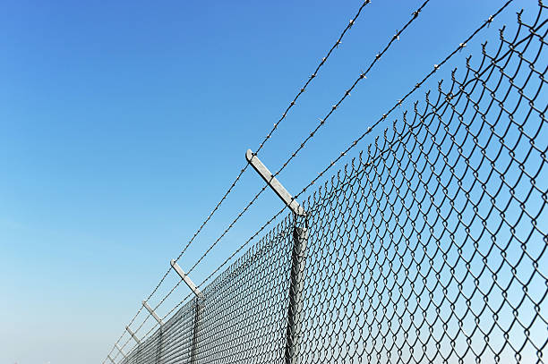 istock iron chain link fence and blue sky 2217838062