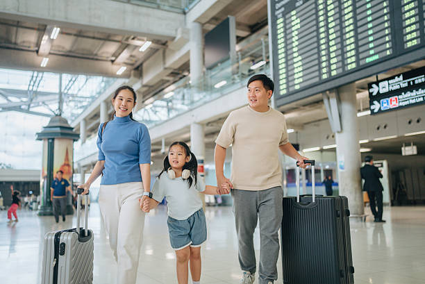 istock Asian passengers with luggage at airport 2217839305