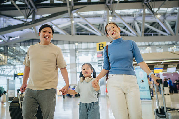 istock Asian passengers with luggage at airport 2217839355
