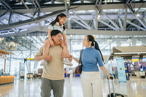 istock Asian passengers with luggage at airport 2217839391