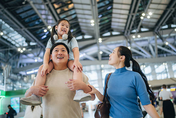 istock Asian passengers with luggage at airport 2217839465