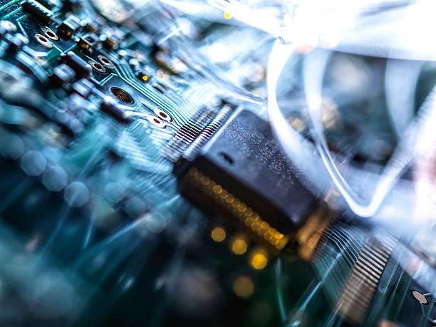 istock Intricate circuit board with fiber optic cables, illustrating technological advancements and connections. 2217839497