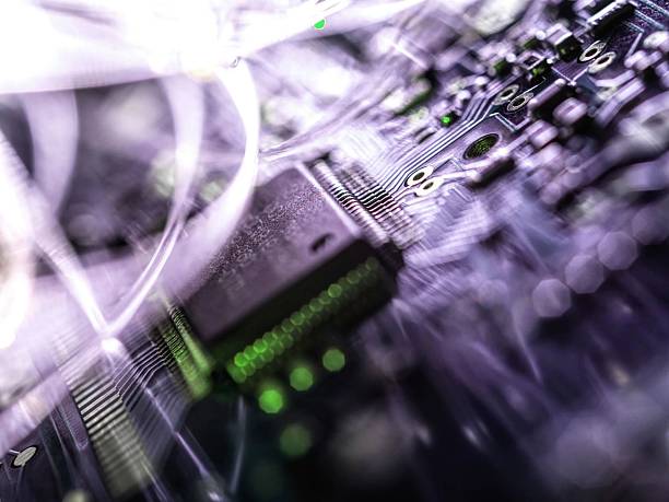 Close-up view of a circuit board with glowing fiber optic cables, representing technology and digital data transfer.