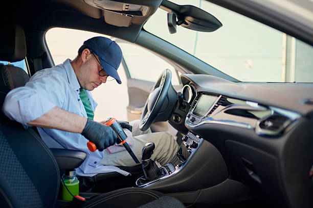 istock Car detailer cleaning vehicle interior using steam cleaner and microfiber cloth 2217844946