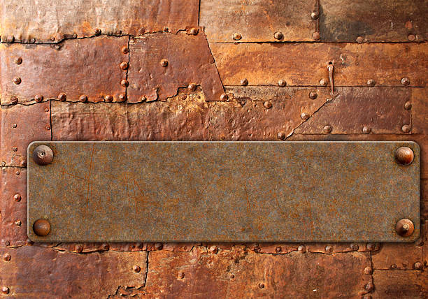 istock Old metallic plank with rivets on rusty metal surface. Vintage metal plate with nails. Can be used for steampunk, retro and vintage design. Mock up template. Copy space for text 2217848300