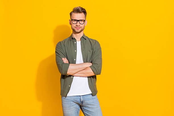 istock Portrait of attractive skilled content guy expert folded arms thinking isolated over bright yellow color background 2217849602