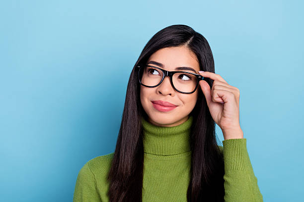 istock Portrait of attractive cheerful intelligent long-haired girl touching specs creating solution isolated over bright blue color background 2217849904