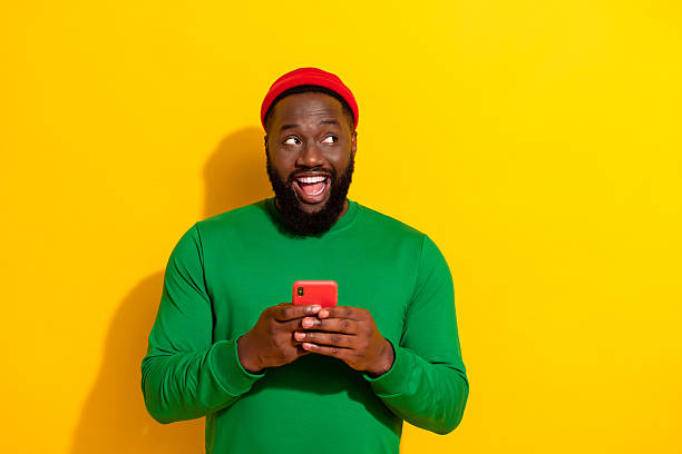 istock Portrait of attractive cheerful guy using device creating new post smm influencer isolated over bright yellow color background 2217849910