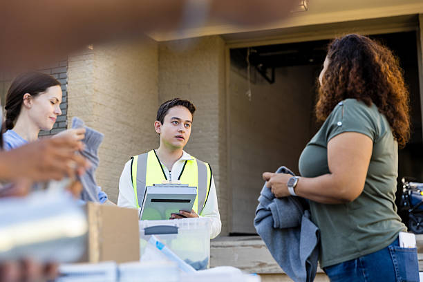 istock Donation Center Volunteer Talking to a Donor 2217851978