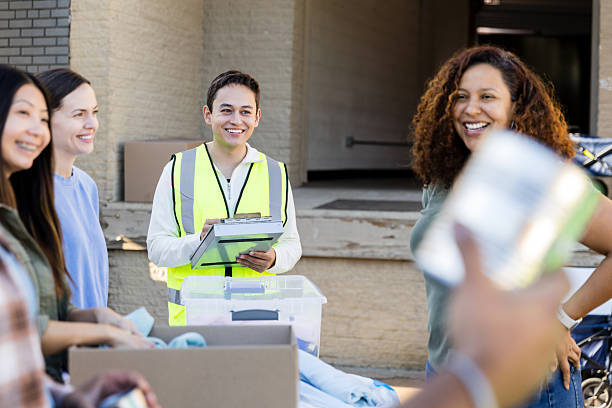 istock Donation Center Volunteer Assisting Women with Donations 2217851981