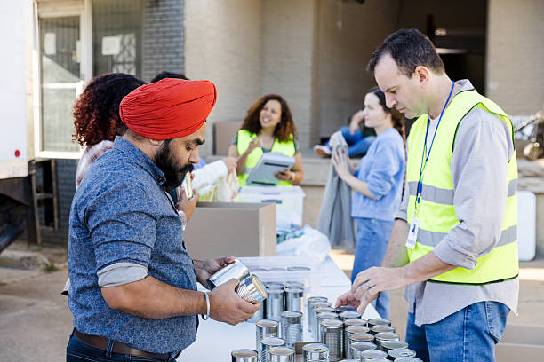 istock Volunteers sorting canned goods at a food bank 2217852013