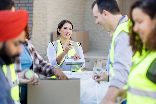 istock Volunteers Working Together at a Community Outreach Event 2217852054
