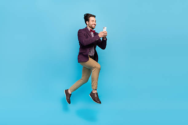 istock Full size profile side photo of young man jump use mobile share repost fast connection isolated over blue color background 2217852520