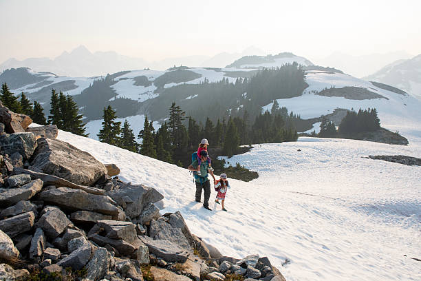 Father and young daughters hike in alpine, Whistler, British Columbia