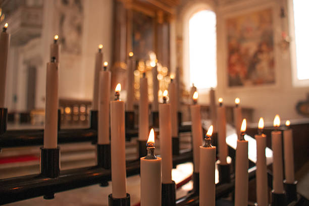 Lit prayer candles in a Catholic church interior