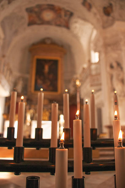istock Lit prayer candles in a Catholic church interior 2217854045