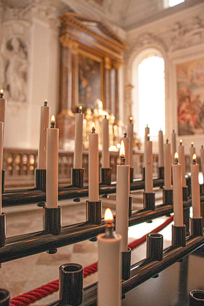 istock Lit prayer candles in a Catholic church interior 2217854047