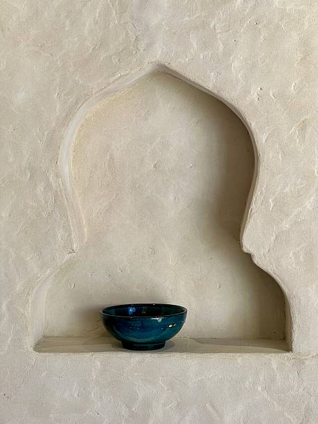 Simple blue bowl placed in a carved wall niche with minimalist style
