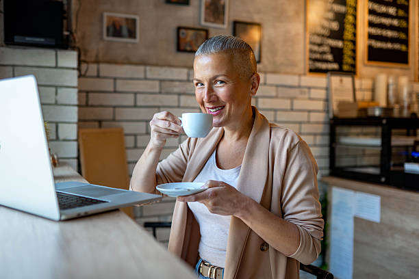istock Woman working on laptop in a coffee shop 2217860696