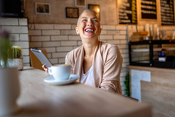 istock Woman working on laptop in a coffee shop 2217860741