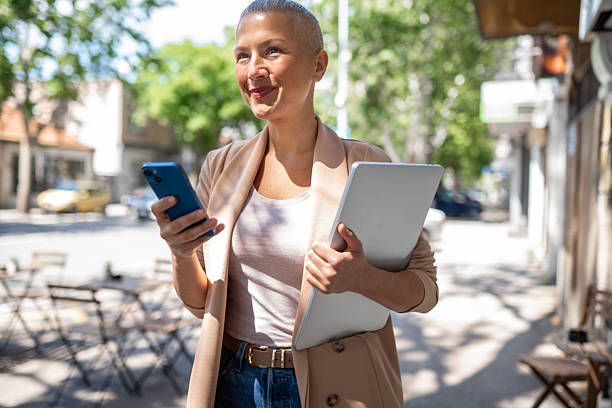 istock Business woman going to work and using phone 2217860765