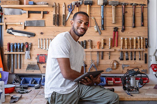 istock Confident Mid-Adult Carpenter Using Digital Tablet In Well-Organized Workshop With Tool Wall 2217862923