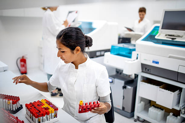 istock Young Indian Female Lab Professional Organizing Blood Samples in a Bright Modern Laboratory 2217864077