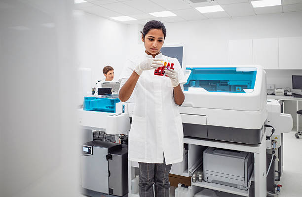 istock Young Medical Laboratory Technician Examining Blood Sample in Modern Clinical Facility 2217864531