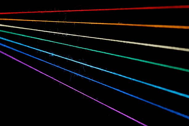 istock multicolored sewing threads in the form of a rainbow on a black background 2217864902
