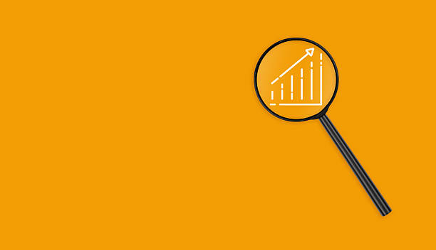 istock Lens with Chart on Orange Background close up 2217865032