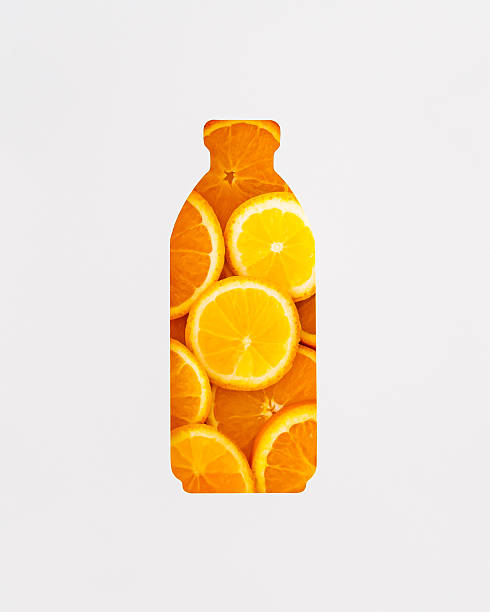 istock Summer composition with orange slices visible through a bottle shaped gap on white background. Minimal orange juice concept. Trendy refreshing and healthy drink idea. Flat lay. Top view banner. 2217870524