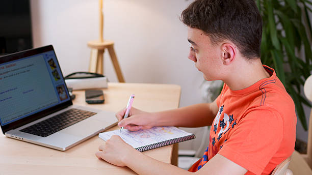 istock Teenager student watching lesson online and studying from home 2217873445