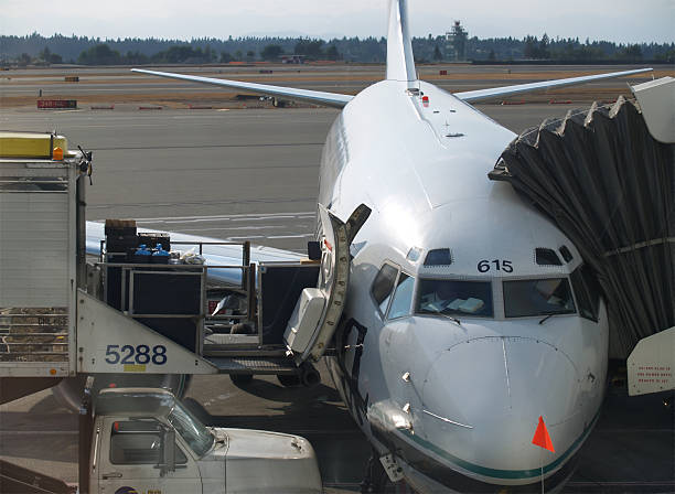 Portland, Oregon, USA - February 25, 2023: An Alaska Airlines 737 lands at a snow covered Portland International Airport with Mt Hood in the background.
