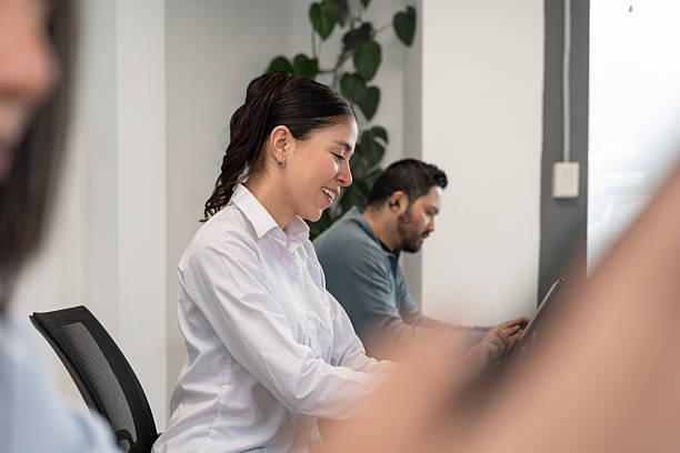 istock Focused woman working on tablet at shared office desk 2217877349