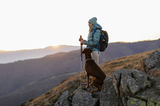 istock Woman with her dog taking a break from hiking 2217877554