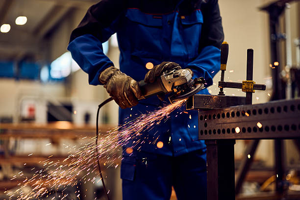 istock Worker Using an Angle Grinder to Cut Metal with Flying Sparks 2217880821