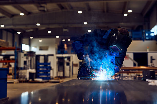 istock Welder Working with Sparks in Industrial Factory Setting 2217880849