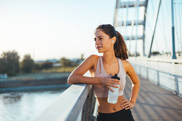 istock Female Athlete Resting on a Bridge with a Water Bottle 2217888233