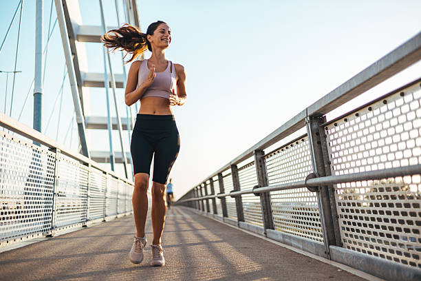 istock Woman Running on a Modern Bridge During a Beautiful Morning 2217888251