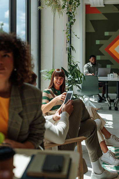 istock Young businesswomen smiling and using tablet in modern office 2217889167