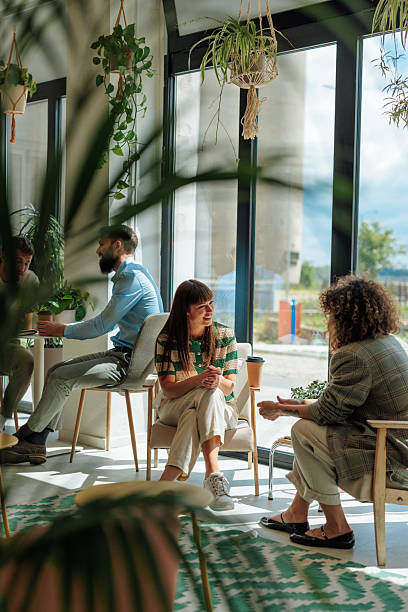 istock Young businesswomen talking in a modern office with plants 2217889189