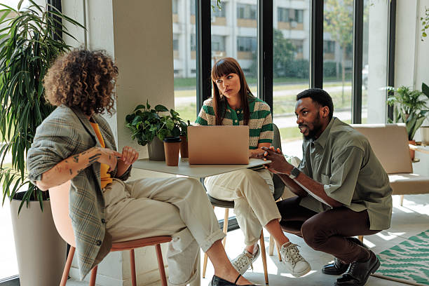istock Colleagues discussing a project using a laptop in a modern office 2217889225