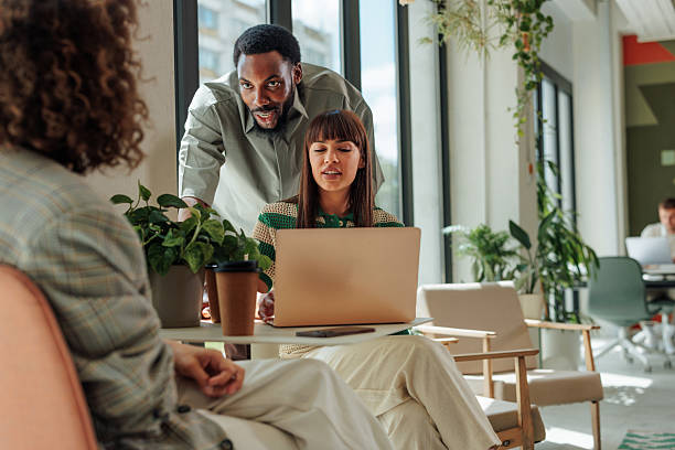 istock Business team collaborating on a project using laptop in modern office 2217889252