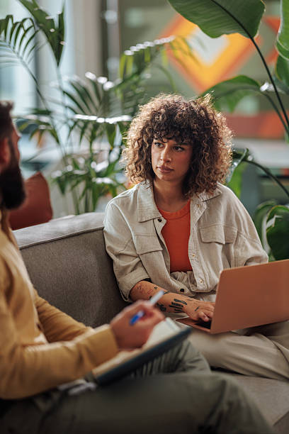 istock Young woman talking with her therapist during therapy session 2217889270